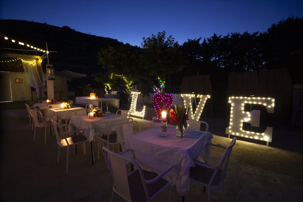 Boda de noche en La Finquita con letras LOVE iluminadas y mesas decoradas en Lupiana